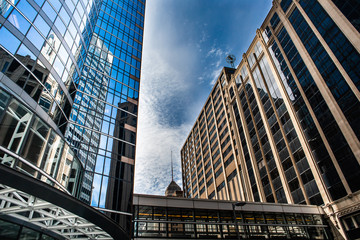 Naklejka premium Reflection of skyscrapers in a reflective building