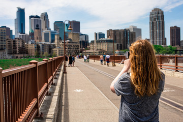 Woman taking picture of city skyline