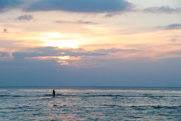 People standing on a small island in middle of a sea pointing up to the sky during a sunset, Koh Samui, Thailand