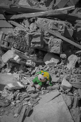 Children's soft toy on the ruins of the building.