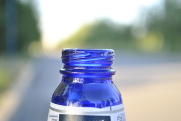 the neck of a blue glass beer bottle