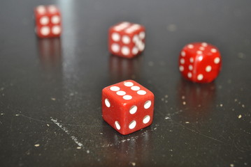 red dices on a black background