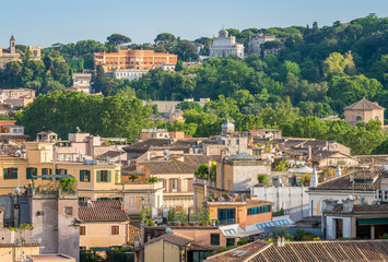 Fototapeta na wymiar Rome skyline as seen from Castel Sant'Angelo with the Acqua Paola Fountain and the Gianicolo Hill in the background.