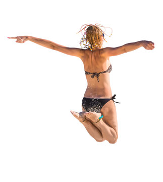Back of happy and attractive woman with black bikini jumping in the air. Isolated on white background. 