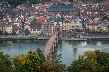 Old Bridge and Old town in Heidelberg with tourists and river Necker