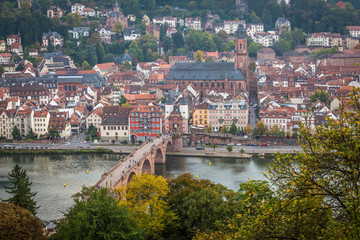 Fototapeta na wymiar Old Bridge and Old town in Heidelberg with tourists and river Necker
