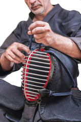 swordsman wear protective equipment 'bogu' and bamboo sword 'sinai'  for Japanese fencing Kendo training seat down