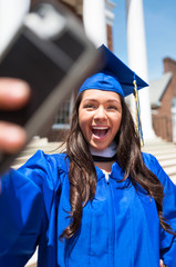 Beautiful female college graduate taking a selfie