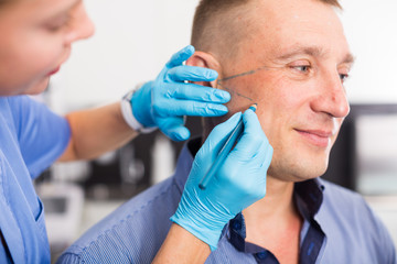 Woman doctor is preparing client for mesotherapy
