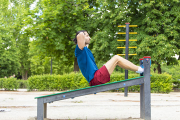 Young man making abdominal push-ups training exercise
