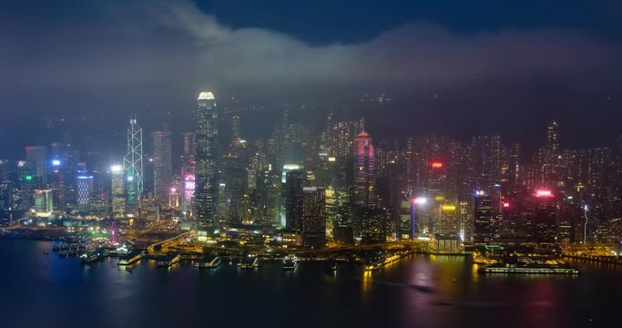 Day to night timelapse of illuminated Hong Kong skyline. Hong Kong, China