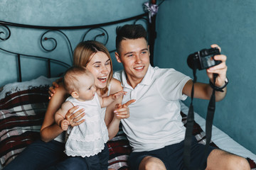 Dad make self portrait with mom and baby daughter