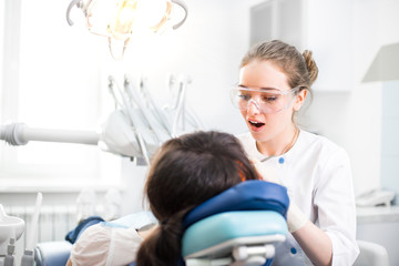 Dentist treats teeth patient in the clinic