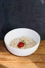 oatmeal with strawberries in a white plate