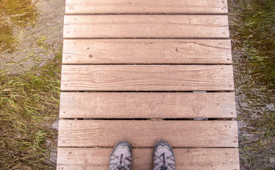 Obraz premium feet on wooden bridge