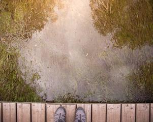 Fototapeta premium feet on wooden bridge