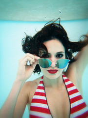beautiful woman portrait underwater with sunglasses