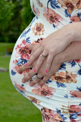 Pregnant woman holding husband's hand on belly