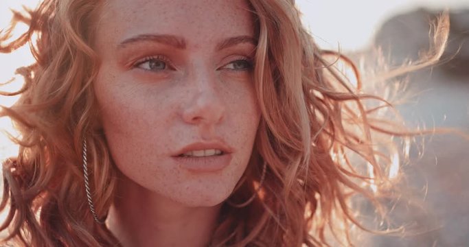 Close-up of beautiful woman with green eyes at the beach