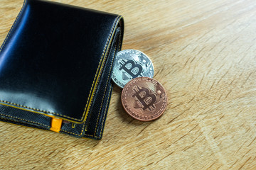 Bitcoin digital currency instead real money, bit-coin with leather wallet or purse on wooden working table, virtual cryptocurrency money business concept.