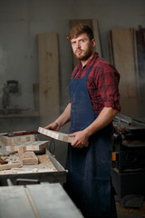 Portrait Male Master carpenter apron in his workshop. Small business
