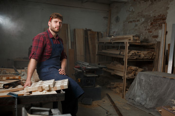 Portrait Male Master carpenter apron in his workshop. Small business
