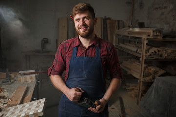 Portrait Male Master carpenter apron in his workshop. Small business