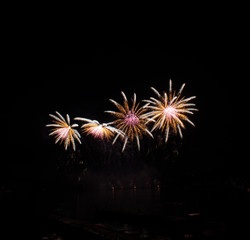 Celebration fireworks over the river with cityscape soft focus background at night scene