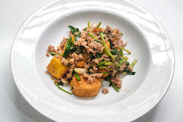 tofu stir fry with pork on white dish