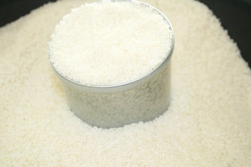 Steel cans (used for measuring rice )and raw rice