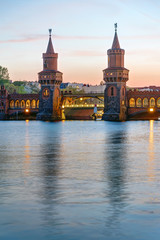 The Oberbaumbridge and the river Spree in Berlin after sunset - obrazy, fototapety, plakaty