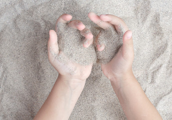The child is playing with the sea sand. Sypet, flying away. Relax, meditation