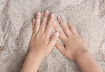 The child is playing with the sea sand. Sypet, flying away. Relax, meditation
