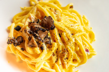Spaghetti with olive oil and black truffle slices in an Italian restaurant