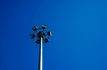 Round steel pole installed spotlights, steel pole with blue sky background.