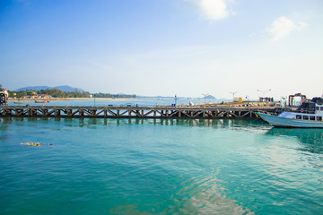 Fototapeta na wymiar The fishing pier and ferry boats. On the island.