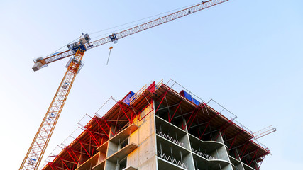 Consrtuction crane near building. Construction site.
