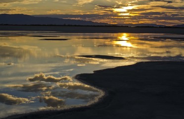 A mirror like reflection on the calm water of the great salt lake in utah