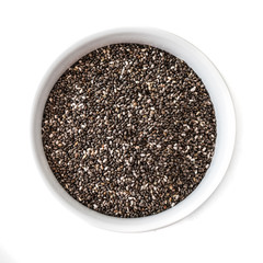 Obraz na płótnie Canvas Bowl of Chia seeds isolated on white background. Closeup. Top view. Chia SuperFood. Healthy eating concept.