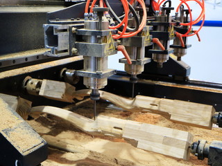 Multi-spindle milling machine manufactures decorative feet for furniture.