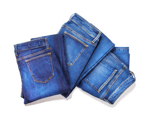 Jeans isolated on white background. Top view of folded blue jeans