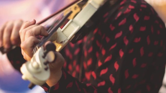 the violinist plays the violin