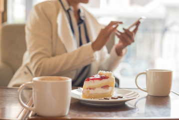Image of young and pretty woman having dessert in cafe