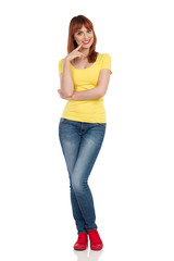 Fototapeta premium Funny Young Woman Is Holding Finger On Chin And Smiling