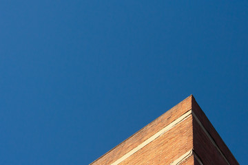 Warehouse corner against blue sky