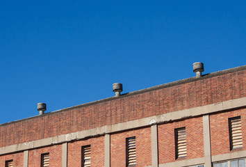 Warehouse roofline against blue sky