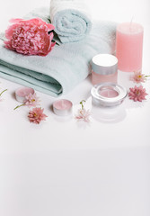 Spa concept in Valentine's Day, Birthday Day, pink peony, candles, blue towels, flowers. Spring or summer background