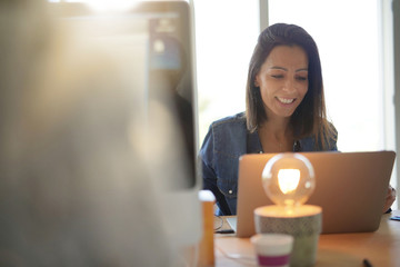 Cheerful girl working in co-working office