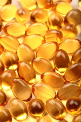 Many cod fish oil capsules background.