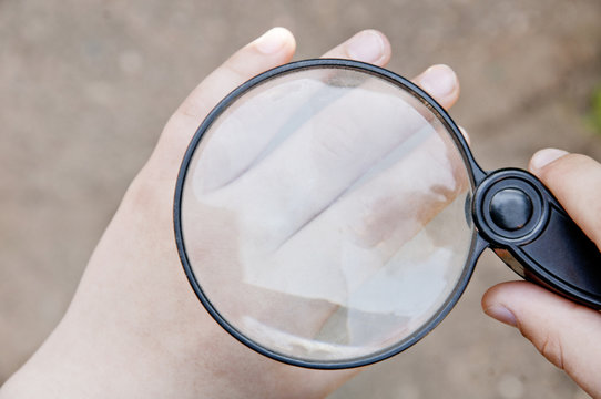 magnifier in the hand of a little child